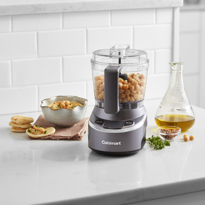 Cuisinart EvolutionX RMC-100 dark-gray cordless mini chopper with four-cup bowl shown with chickpeas and dip