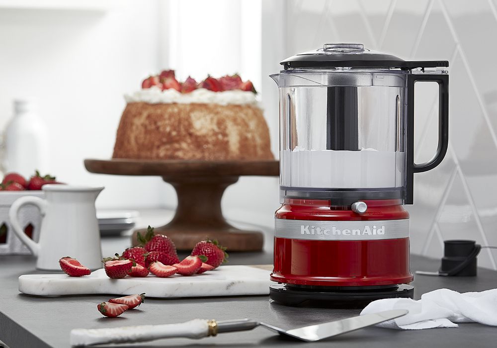 KitchenAid KFC0516ER five-cup chopper in Empire Red shown on a countertop in the manufacturer feature scene