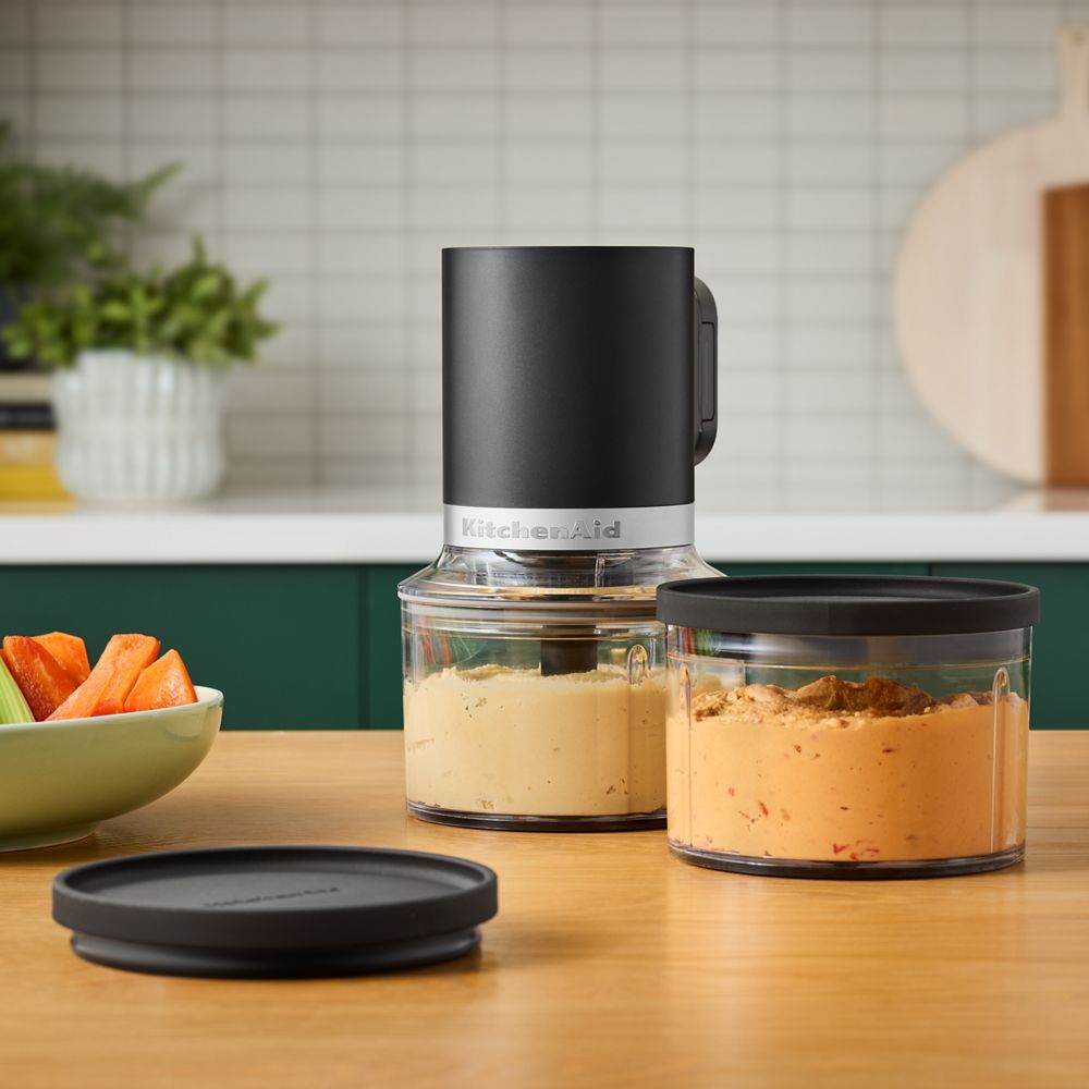 KitchenAid Go KTCR351SBM top-down chopper package staged with two clear work bowls and a dark storage lid.