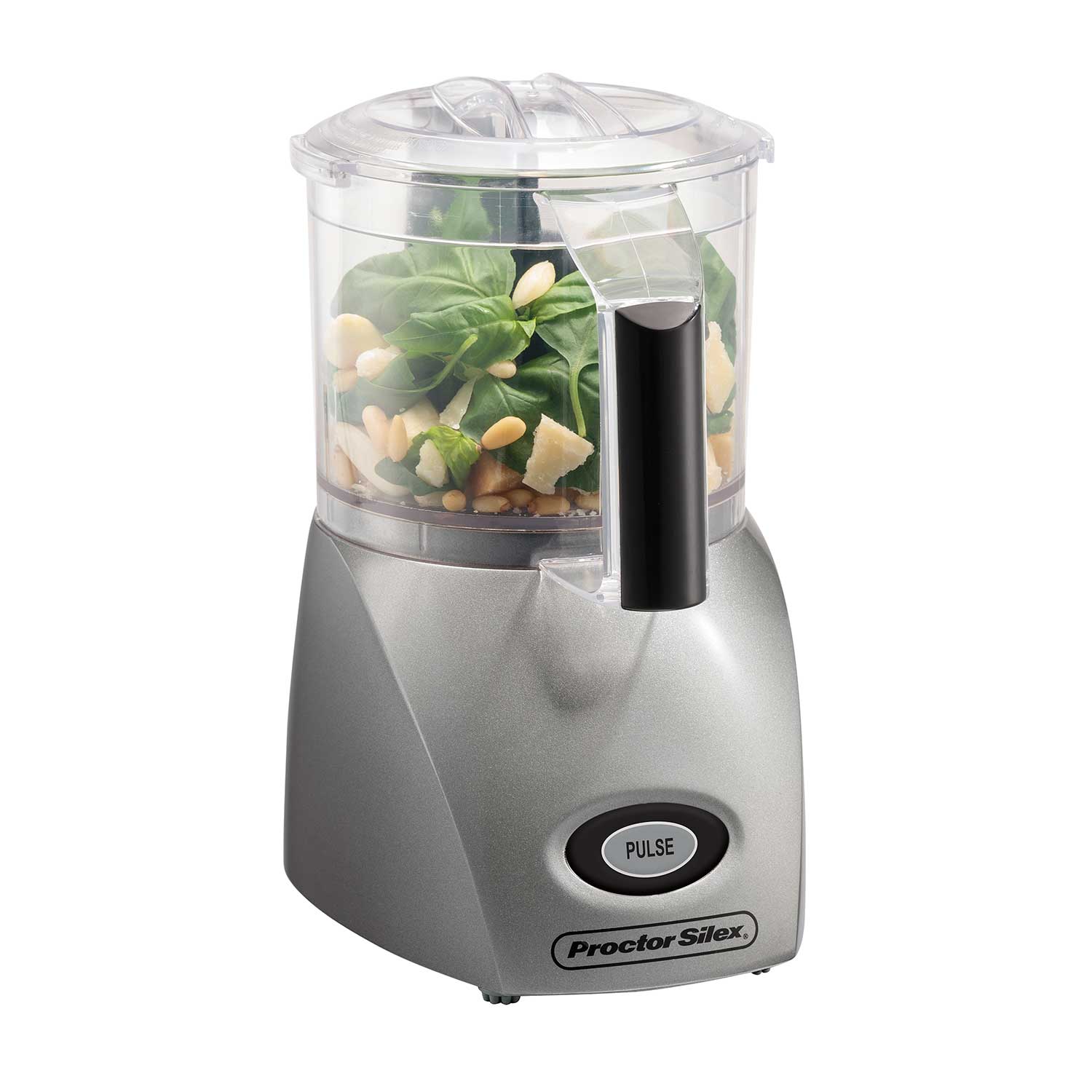 Proctor Silex 72706 three-cup mini processor with silver-gray base, clear bowl, oil-dispenser lid and staged pesto ingredients